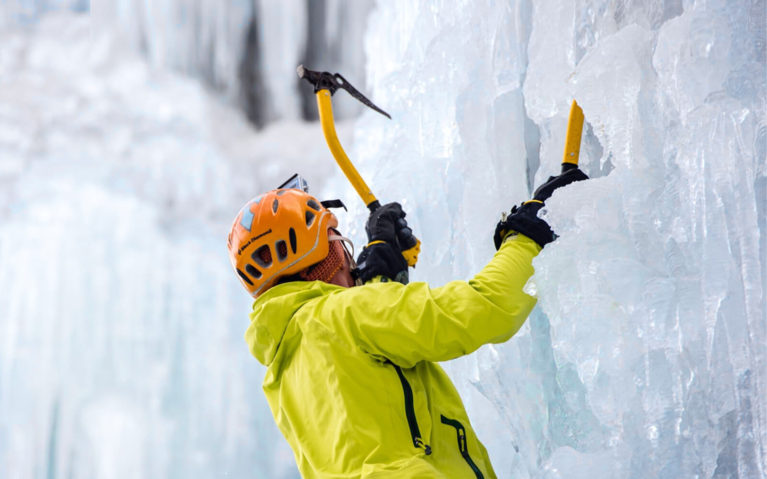 Man in Yellow Jacket Ice Climbing with Two Axes :: I've Been Bit! Travel Blog