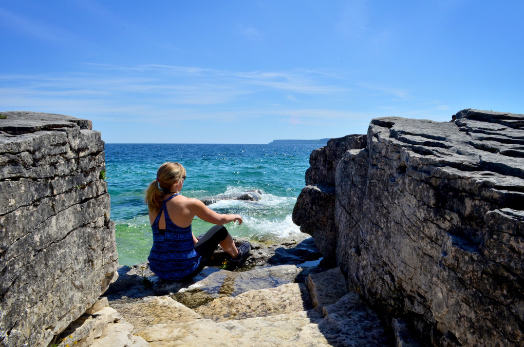 Lindsay sitting on the shores of Georgian Bay in Bruce Peninsula National Park :: I've Been Bit! Travel Blog