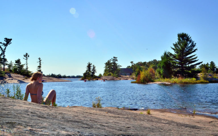 Lindsay Sitting on Canadian Shield Shoreline :: I've Been Bit! Travel Blog