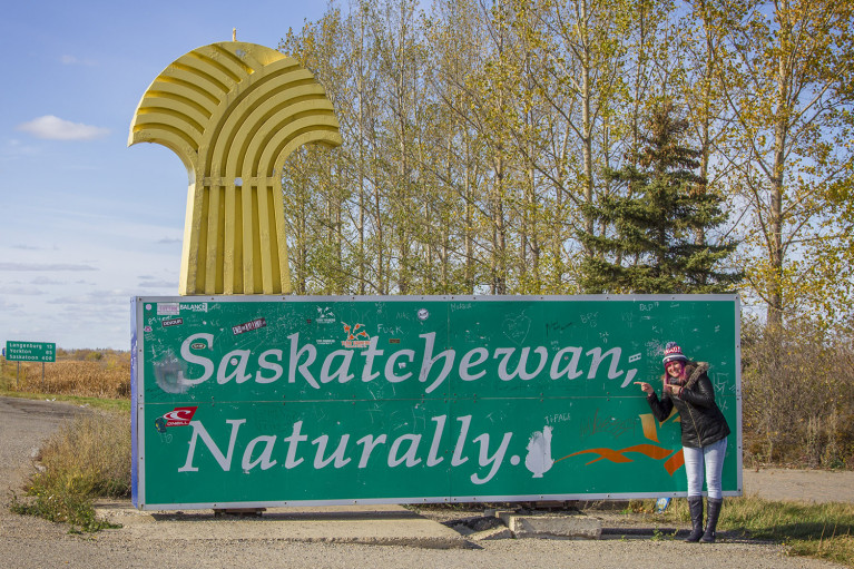 Posing with Saskatchewan Sign, Manitoba Road Trip - 7 Days of Canadian Prairie Adventure :: I've Been Bit A Travel Blog