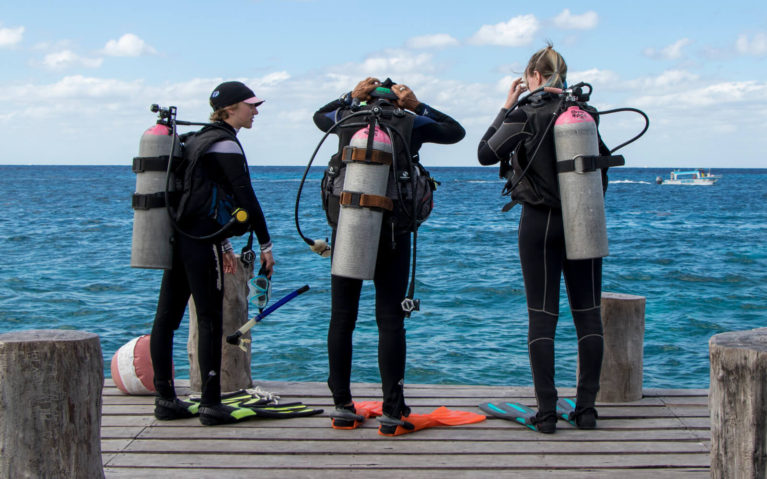 Three Scuba Divers Standing on Dock in Cozumel Mexico :: I've Been Bit! A Travel Blog