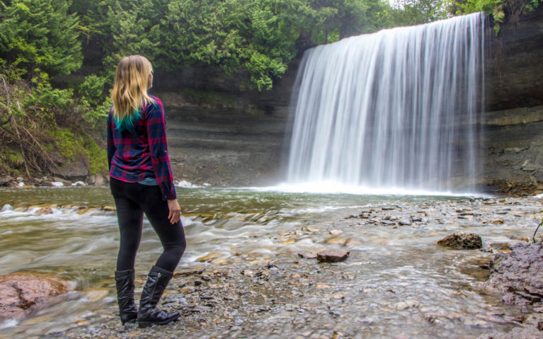 Lindsay Standing At the Base of Bridal Veil Falls on Manitoulin Island, Ontario :: I've Been Bit! Travel Blog