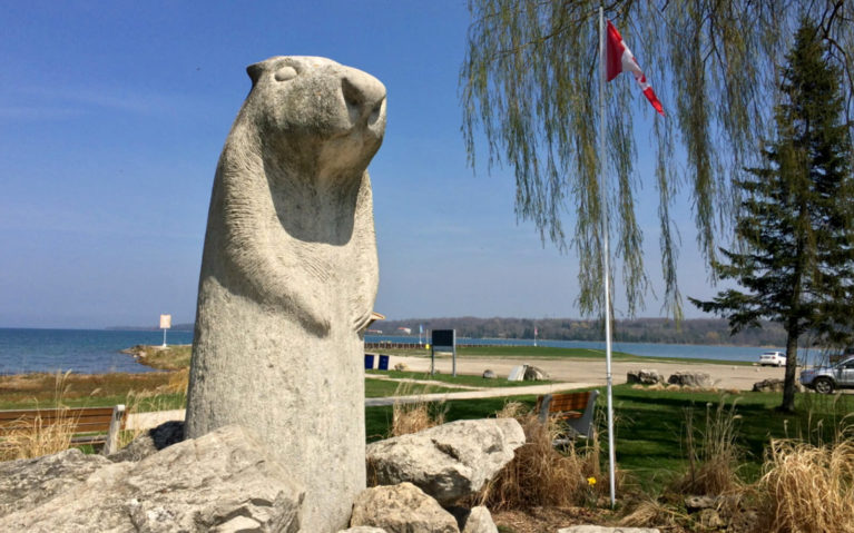 View of Bluewater Park Beside the Wiarton Willie Monument with the Canadian Flag in the Background :: I've Been Bit! Travel Blog