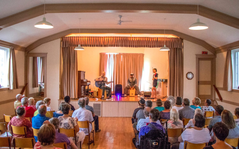 View of People Seated from the Back of the Hall at the Drew McIver Concern at Colpoy's Bay Women's Institute :: I've Been Bit! Travel Blog