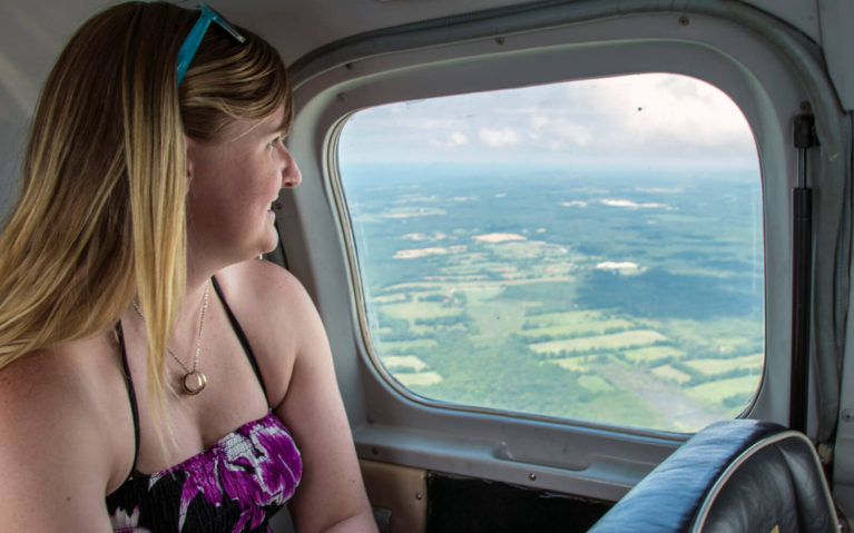 Lindsay Looking Outside the Window on the Flight from Toronto to Wiarton Ontario :: I've Been Bit! Travel Blog