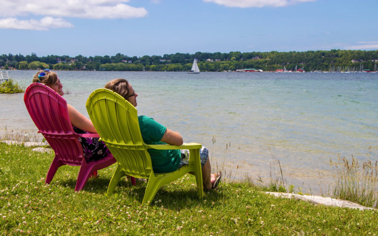 Lindsay and Robin Sitting in Muskoka Chairs on the Shores of Georgian Bay :: I've Been Bit! Travel Blog