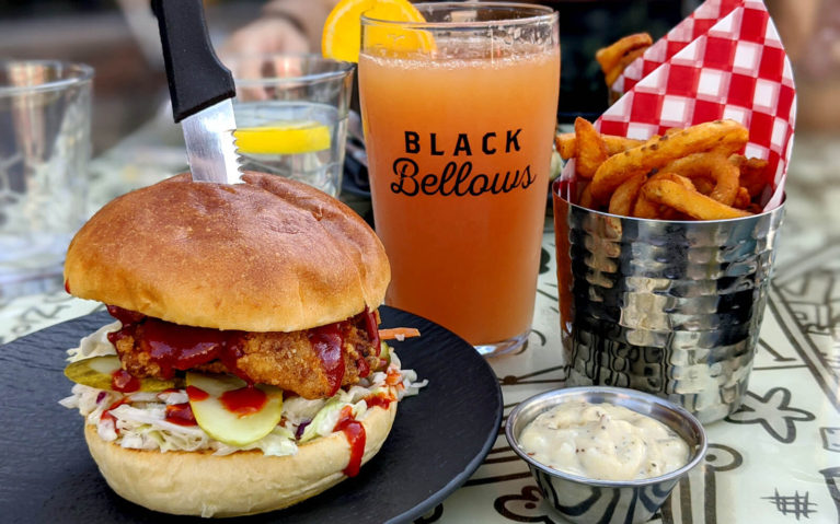 Fried Hot Chicken Sandwich beside a Grapefruit Radler with Curly Fries and their Garlic Parmesan Dip :: I've Been Bit! Travel Blog