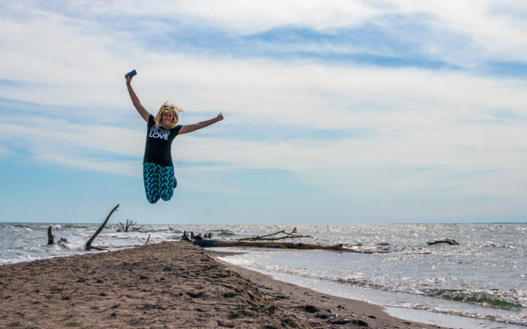 Lindsay in Mid Air at The Tip in Point Pelee National Park :: I've Been Bit! Travel Blog