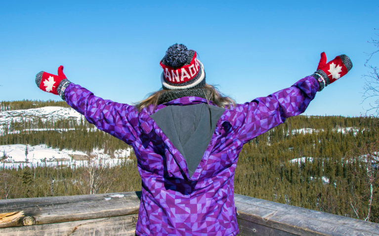 Lindsay with Her Arms Outstretched Wearing a Canada Hat and Mitts :: I've Been Bit! Travel Blog