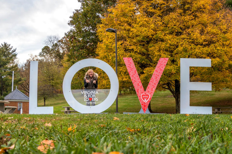 Lindsay Posing with One of the Virginia LOVEworks on this Virginia Road Trip :: I've Been Bit! Travel Blog