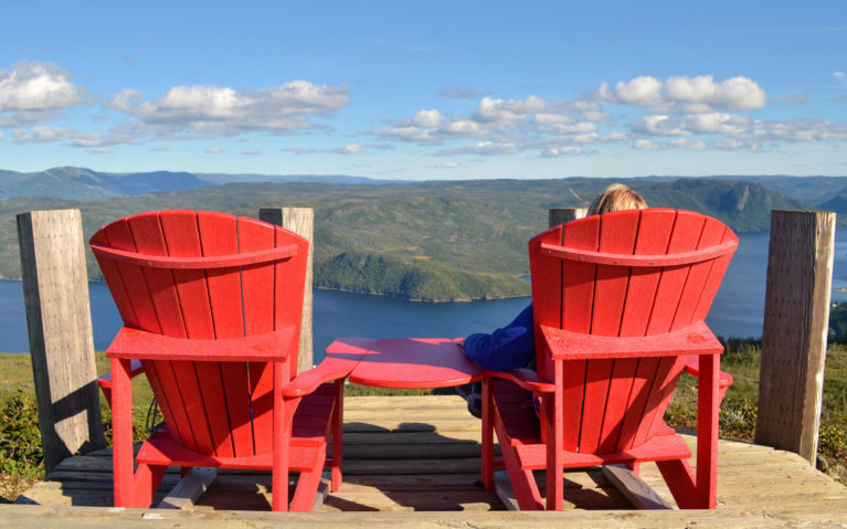Lindsay Sitting on the Parks Canada Chairs in Gros Morne National Park :: I've Been Bit! Travel Blog