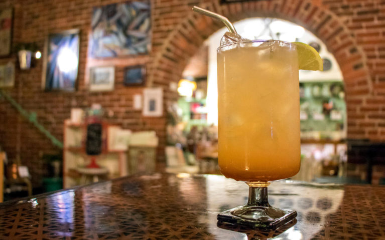 Close Up of Mixed Drink with Exposed Brick Wall Behind :: I've Been Bit! Travel Blog