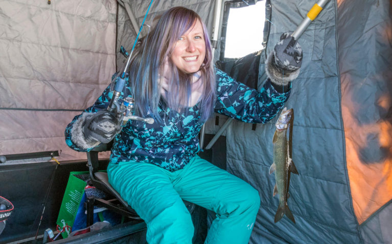 Lindsay Holding a Lake Trout in an Ice Fishing Shelter :: I've Been Bit! Travel Blog