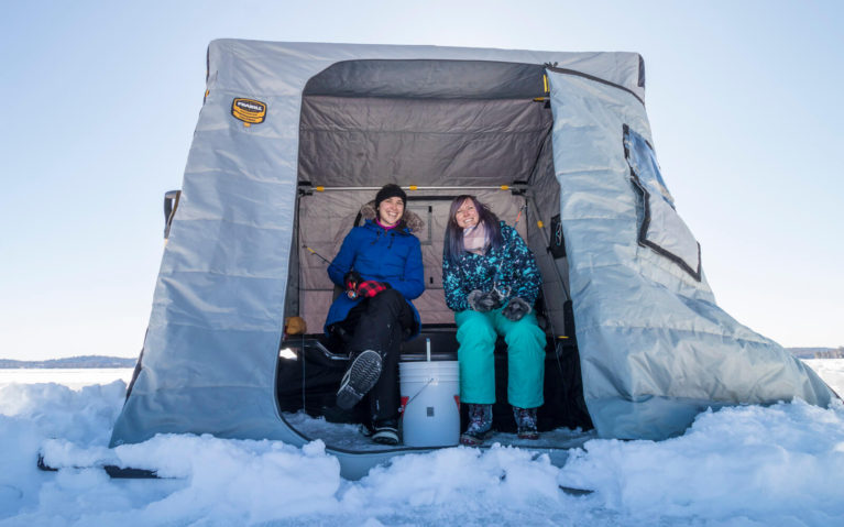 Tara and Lindsay Ice Fishing inside Hut on Windy Lake :: I've Been Bit! Travel Blog
