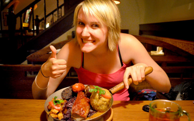 Lindsay with a platter of meat and a thumbs up :: I've Been Bit! Travel Blog