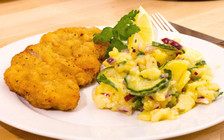 Traditional Wiener Schnitzel with Potato Salad on a White Plate :: I've Been Bit! Travel Blog