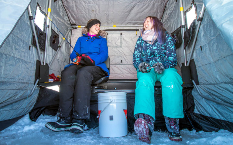 Tara and Lindsay Ice Fishing in the Hut at Windy Lake Provincial Park :: I've Been Bit! Travel Blog
