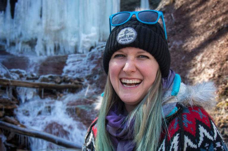 Lindsay Smiling with Frozen Waterfall Behind Her :: I've Been Bit! Travel Blog