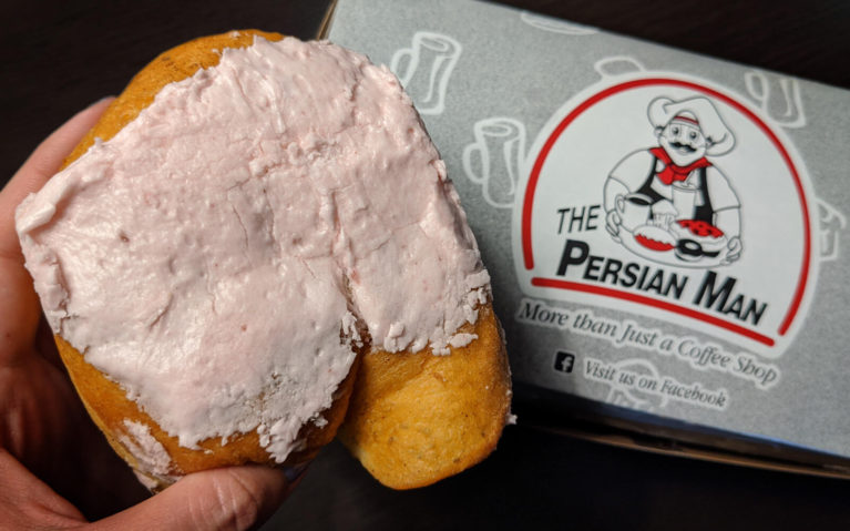 Donut with Pink Icing With Grey Persian Man Box Behind It :: I've Been Bit! Travel Blog