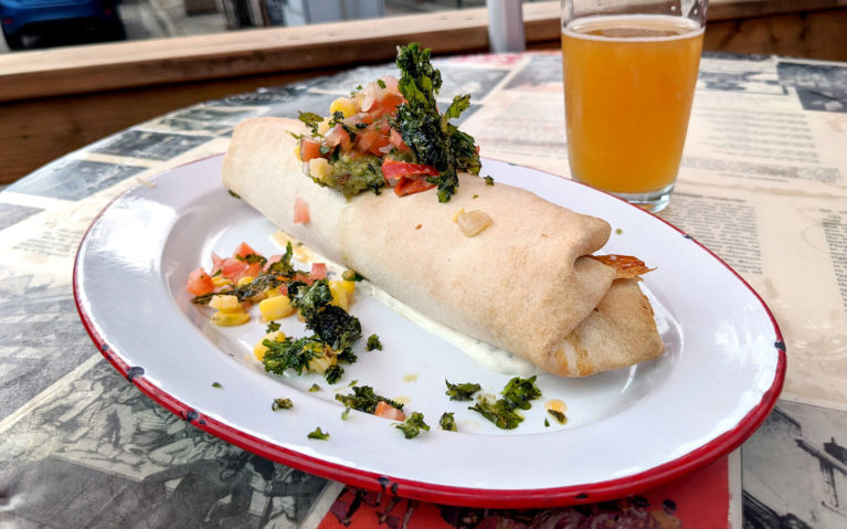 Burrito on a Plate with Garnish and a Beer in the Background :: I've Been Bit! Travel Blog