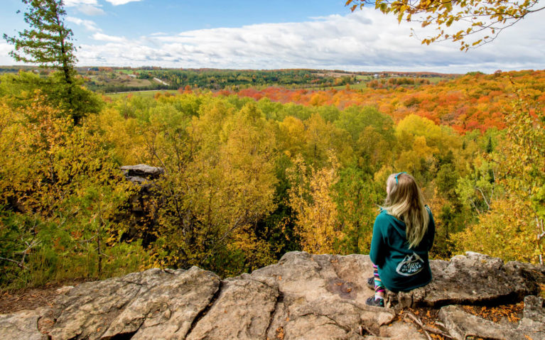 Lindsay Sitting On a Ledge at the Nottawasaga Bluffs Lookout :: I've Been Bit! Travel Blog