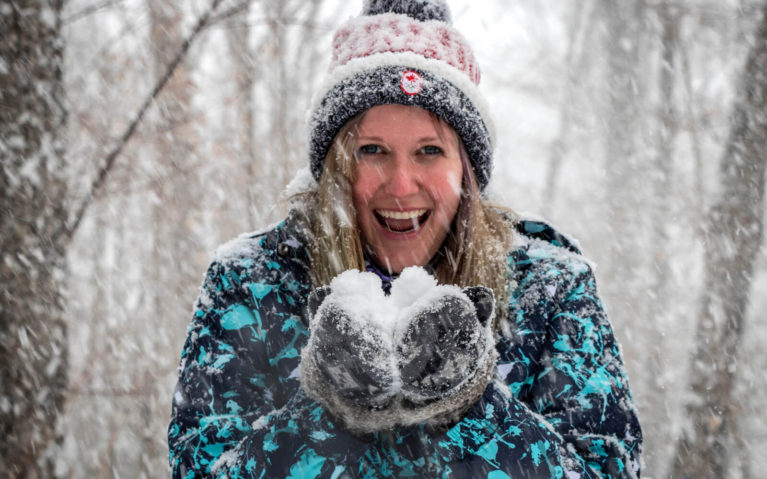 Lindsay Smiling in a Snowstorm While Holding Snow :: I've Been Bit! Travel Blog