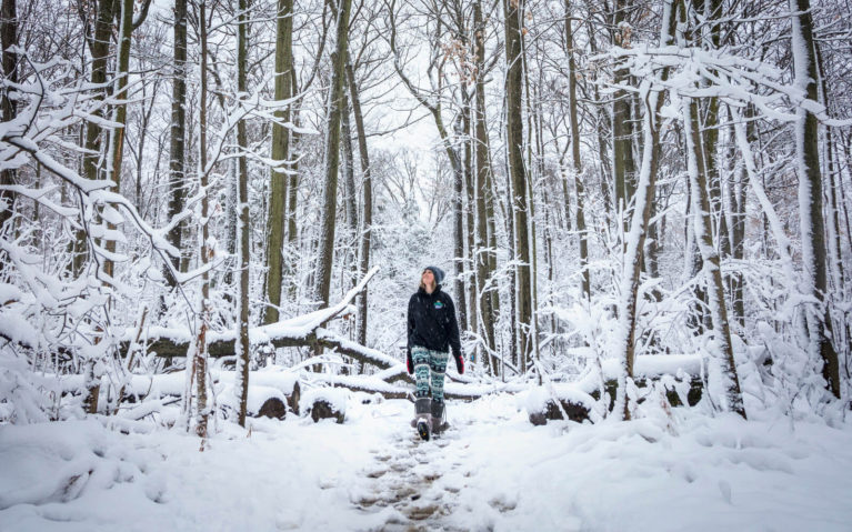 Lindsay Hiking Along a Snowy Trail Surrounded By Tall Trees :: I've Been Bit! Travel Blog