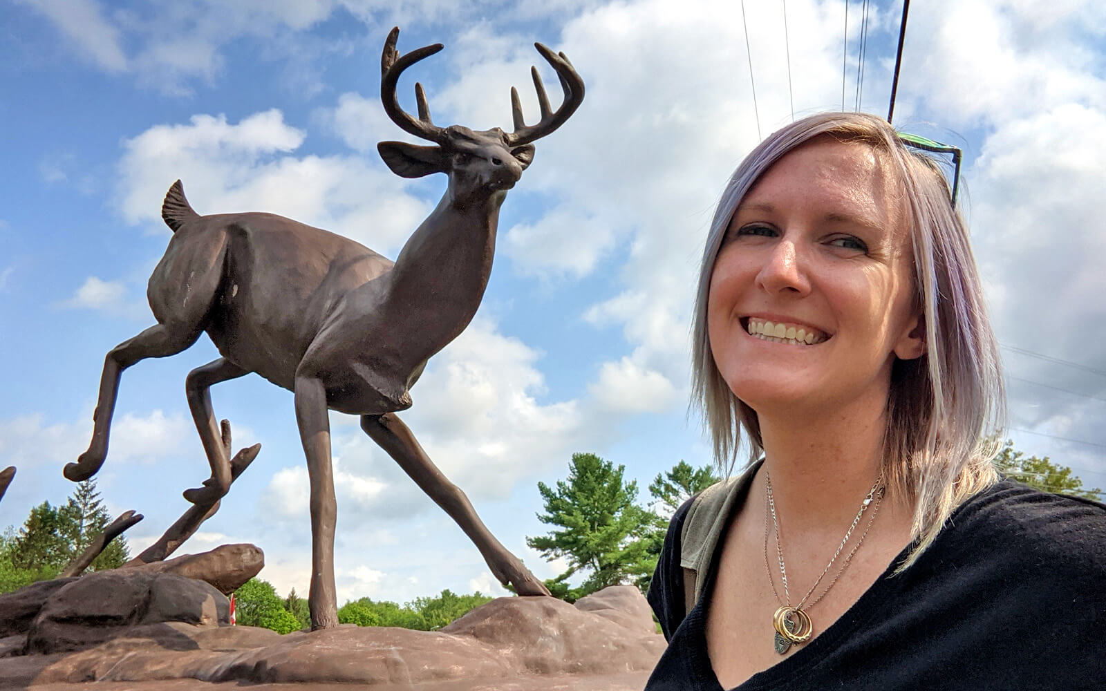 Lindsay Smiling With the Buck Statue in Buckhorn :: I've Been Bit! Travel Blog
