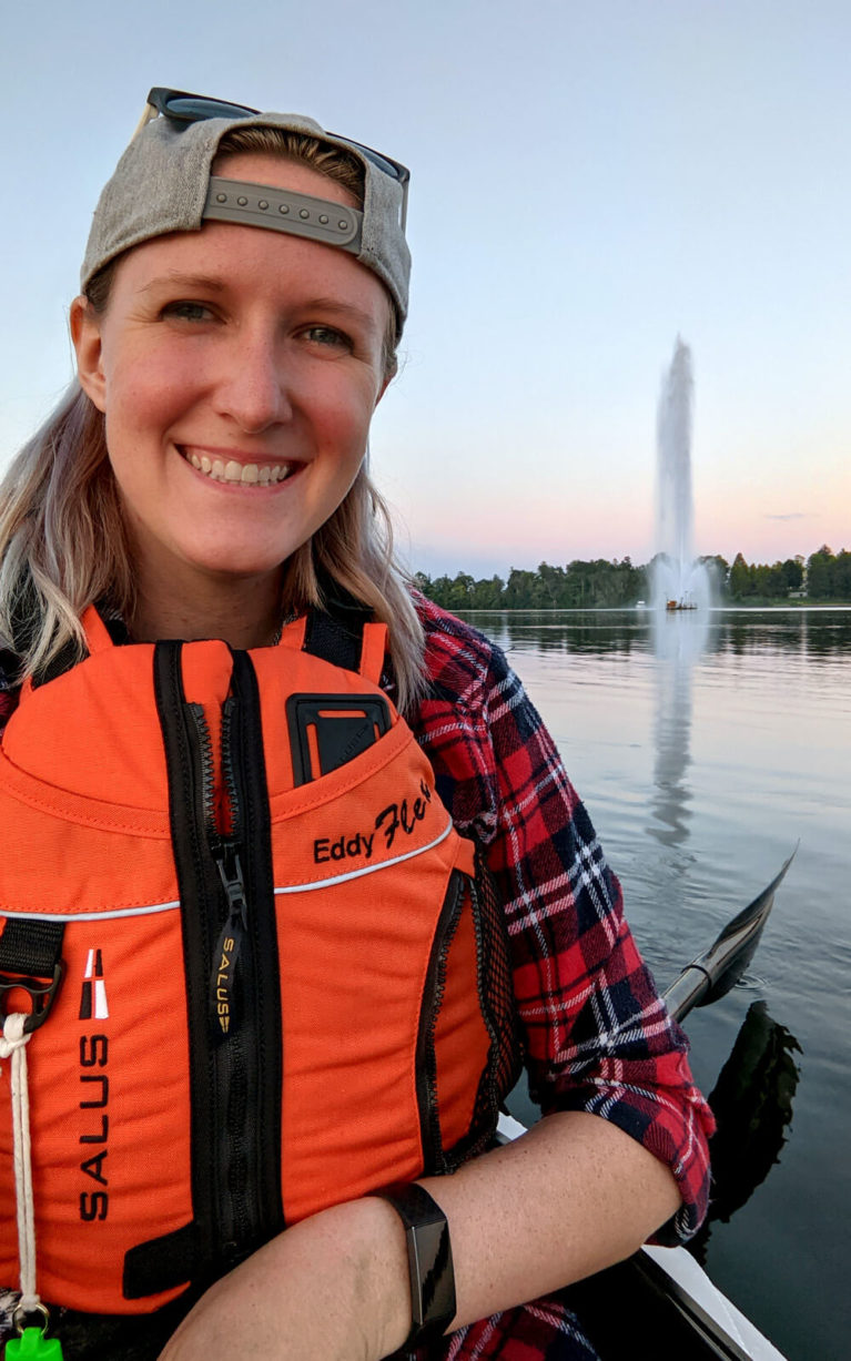 Lindsay Smiling in Her Kayak in Front of the Centennial Fountain on Little Lake :: I've Been Bit! Travel Blog