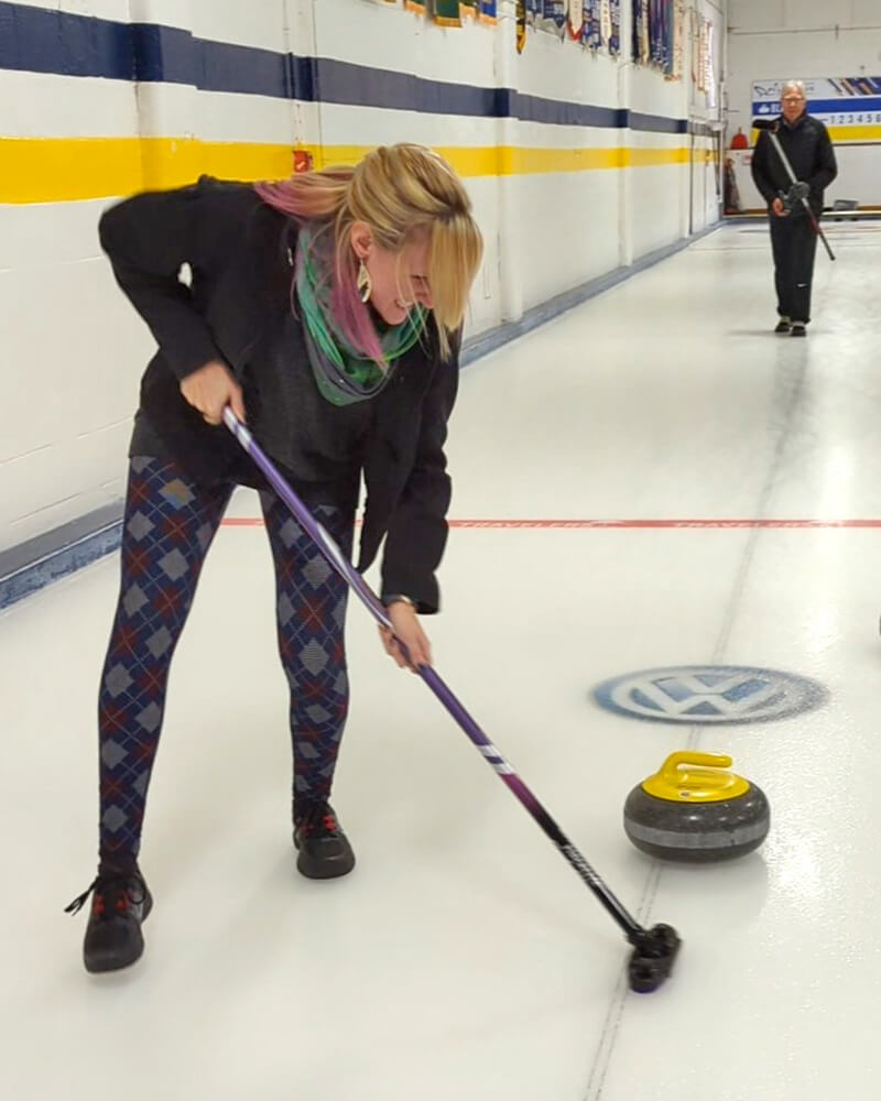 Lindsay Sweeping a Curling Rock in Thunder Bay :: I've Been Bit! Travel Blog