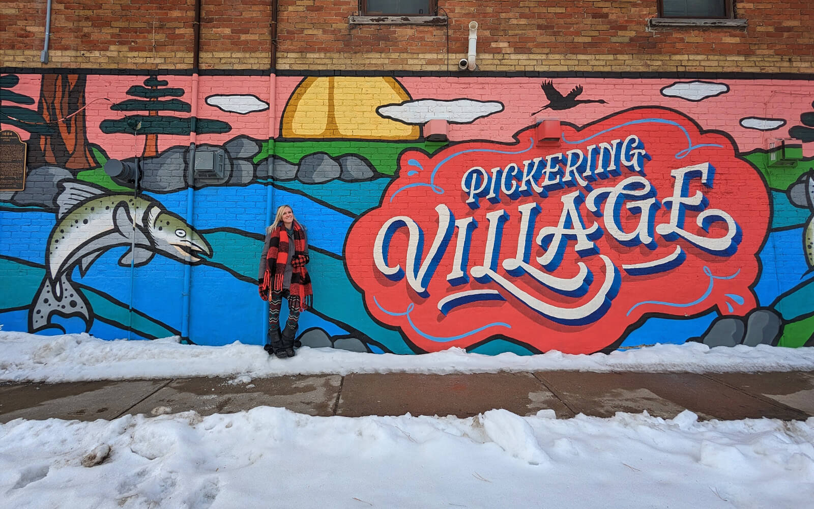 Lindsay Standing in Front of the Brightly Coloured Pickering Village Mural in Ajax :: I've Been Bit! Travel Blog