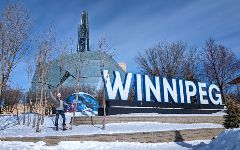 Lindsay With the Winnipeg Sign at The Forks :: I've Been Bit! Travel Blog