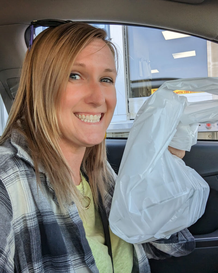 Lindsay Holding Bag in Front of Baba's Drive Thru Window :: I've Been Bit! Travel Blog