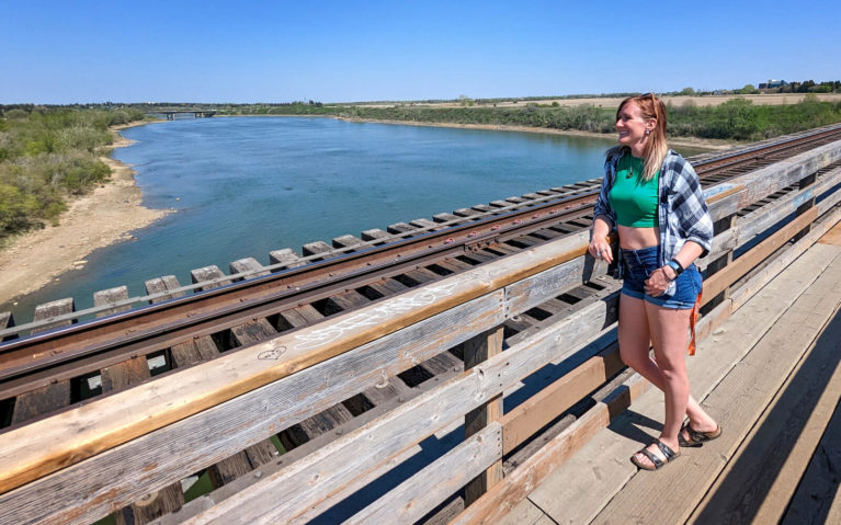 Lindsay Looking Out Over the South Saskatchewan River from the CPR Bridge in Saskatoon :: I've Been Bit! Travel Blog
