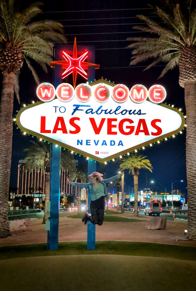 Lindsay Jumping Under the Welcome to Fabulous Las Vegas Sign :: I've Been Bit! Travel Blog