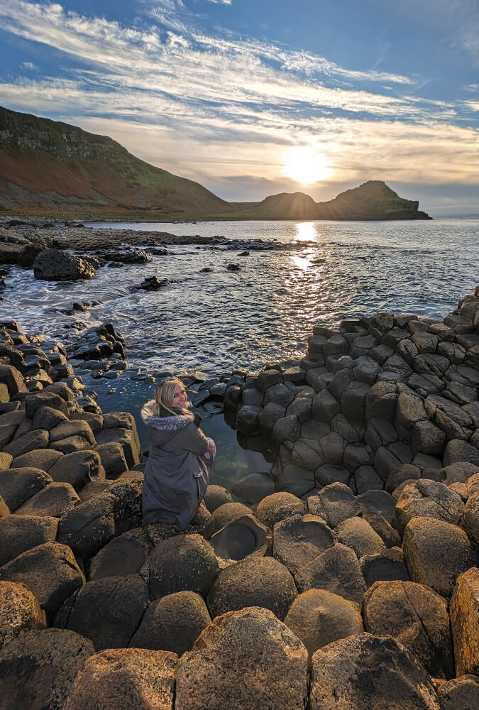 Lindz Sitting At the Edge of the Giant's Causeway :: I've Been Bit! Travel Blog