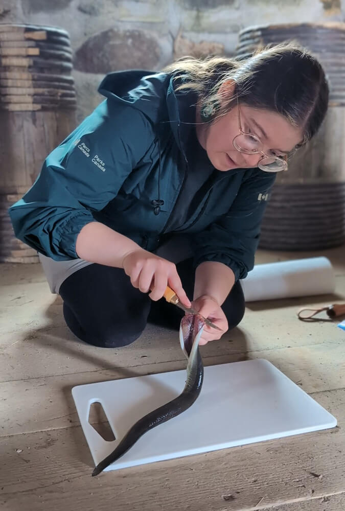 Parks Canada Interpreter Skinning an Eel for the Mi'kmaq Demonstration :: I've Been Bit! Travel Blog