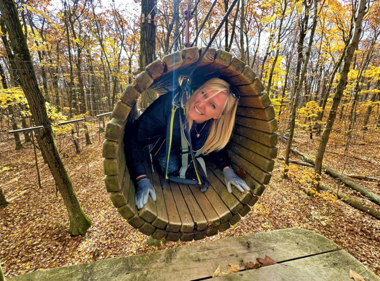 Lindz Climbing Through One of the Obstacles at Bristol Mountain Aerial Adventues :: I've Been Bit! Travel Blog