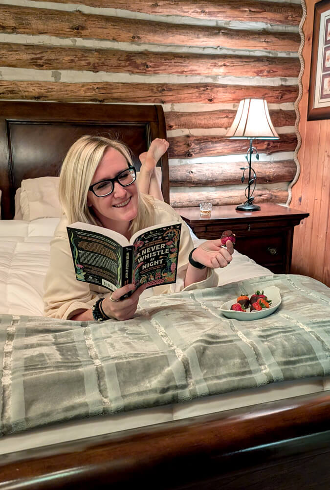 Lindz lounging on the bed in the Lee Suite at the Chalet at Canandaigua :: I've Been Bit! Travel Blog