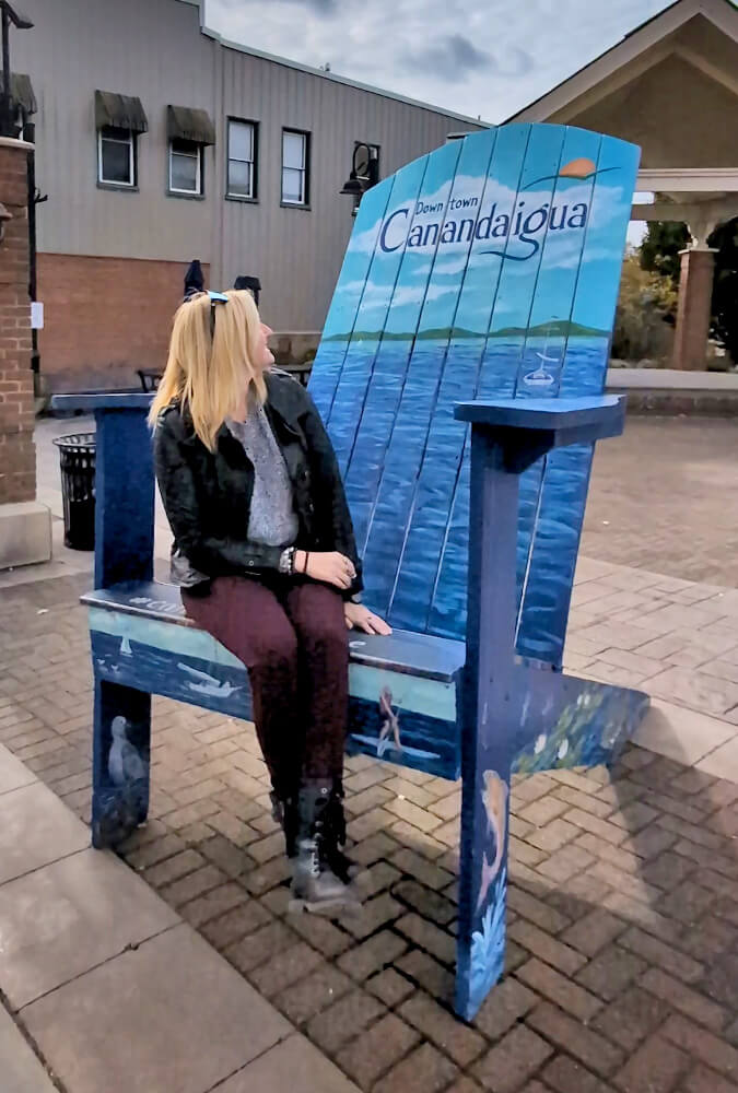 Lindz Sitting on a Giant Muskoka Chair Painted with Canandaigua Lake :: I've Been Bit! Travel Blog